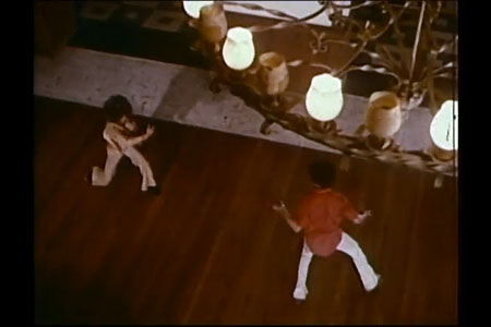 High angle shot. Two figures fighting, viewed from above.