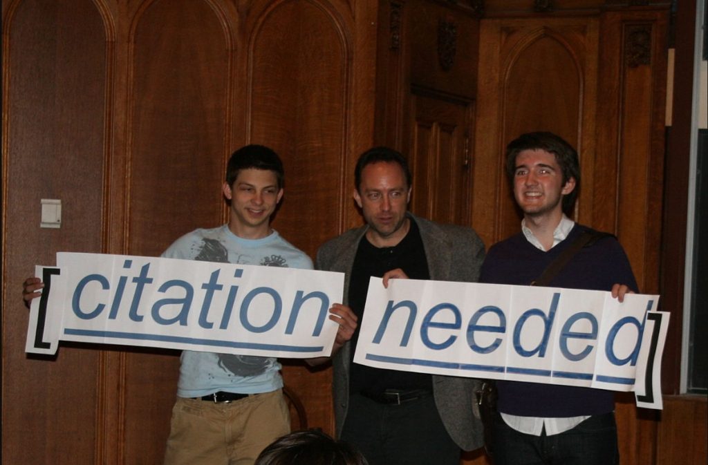 Citation Needed - Writing Commons Jimmy Wales and two others hold aloft a Citation Needed sign