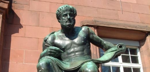 statue of Aristotle by a building in Freiburg, Germany - photo “Aristotle” by maha-online is licensed under CC BY-NC-SA 2.0